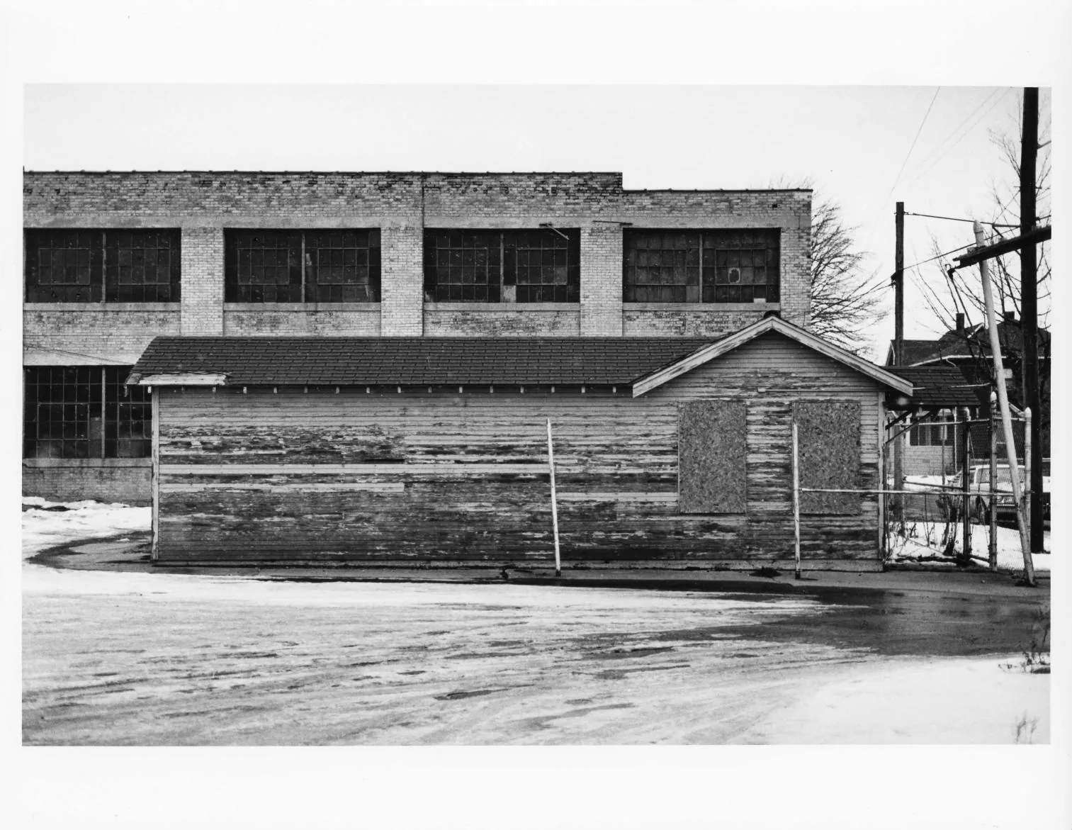 Black-and-white photographs of the Buescher Band Instrument Company Building, 1986: Detached Frame Shed Front (1986)
