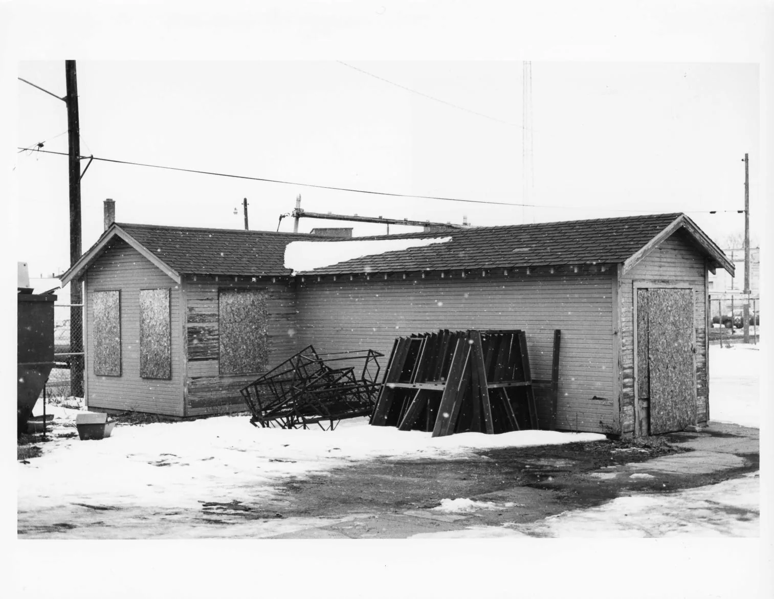 Black-and-white photographs of the Buescher Band Instrument Company Building, 1986: Detached Frame Shed with Debris (1986)